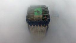 TOPSHOT - A building appears through a thick layer of fog in Yangzhou, in China's eastern Jiangsu province on January 2, 2017. Thick fog reduced visibility in the city, sometimes down to 50 meters. / AFP / STR / China OUT        (Photo credit should read STR/AFP/Getty Images)