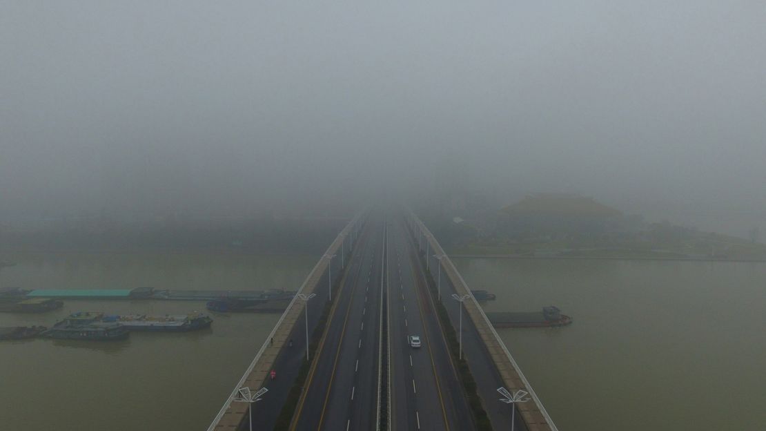 More fog envelops cars crossing a bridge in Yangzhou, in China's eastern Jiangsu province.