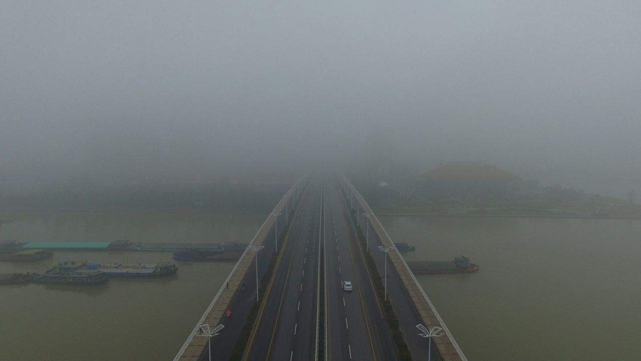 More fog envelops cars crossing a bridge in Yangzhou, in China's eastern Jiangsu province.
