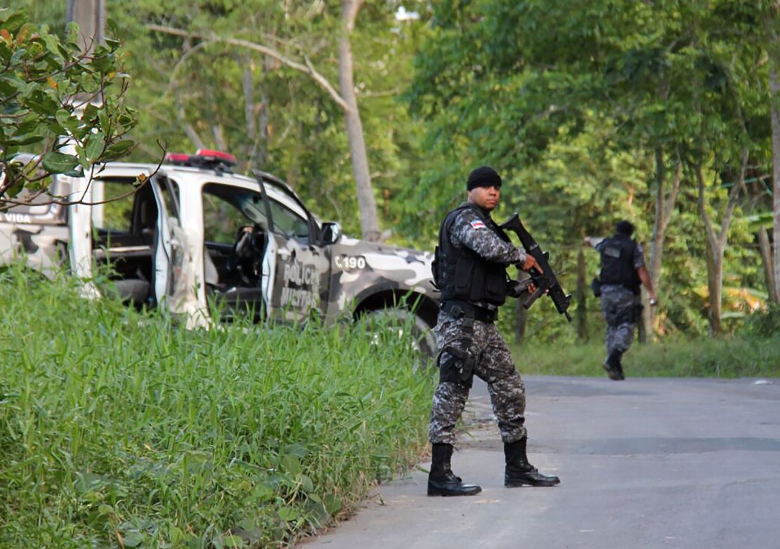 Military police officers track possible fugitives of the Anisio Jobim Penitentiary Complex after a 17-hour riot broke out Sunday. 