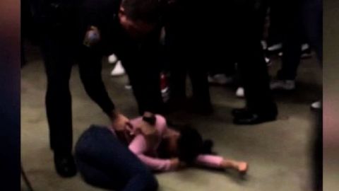 A still from the video, which shows the officer hoisting the student and then slamming her to the floor. 