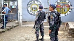 Armed police stand guard at the gates of the district jail, where more than a hundred inmates escaped from, in the town of Kidapawan, in southern island of Mindanao on January 4, 2017.
More than 150 inmates of the southern Philippine jail escaped when suspected Muslim rebels stormed the dilapidated facility in a pre-dawn raid on Janaury 4, killing one guard, authorities said. / AFP / FERDINANDH CABRERA        (Photo credit should read FERDINANDH CABRERA/AFP/Getty Images)