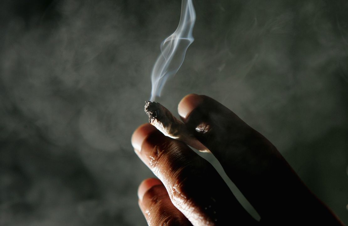 Jonathan Beaver of San Francisco holds a marijuana cigarette at the San Francisco Patients Cooperative, a medical cannabis cooperative, in San Francisco on November 29, 2004. 