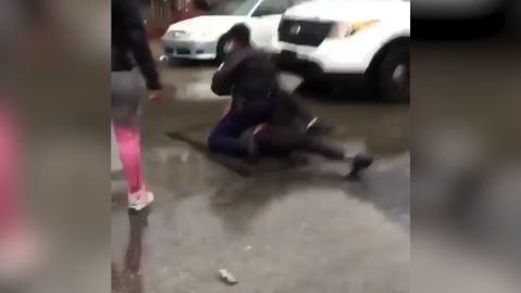 A still image from a video shows the unidentified officer on top of the teen.