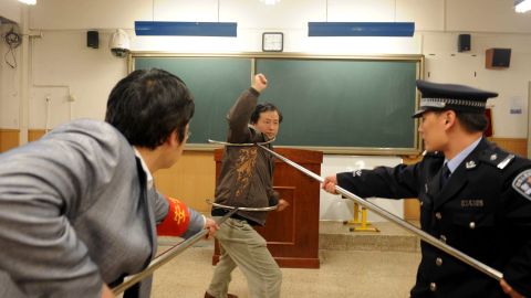 Chinese policemen show teachers and school workers how to defend themselves during an attack at a school in Beijing on April 2010. 