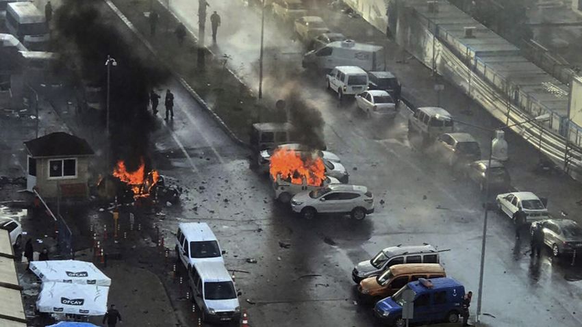 Cars burn after a car bomb explosion in Izmir, Turkey, Thursday, Jan. 5, 2017. An explosion believed to have been caused by a car bomb in front of a courthouse in the western Turkish city of Izmir on Thursday wounded several people, a local official said. Two of the suspected attackers were killed in an ensuing shootout with police. (DHA-Depo Photos via AP)
