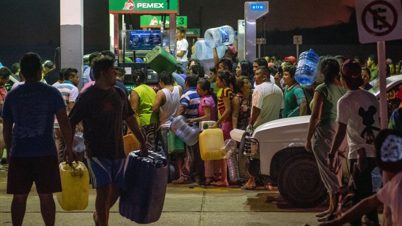 Residents steal gasoline and diesel from a gas station following protests against an increase in fuel prices in Allende, Mexico, on Tuesday. 