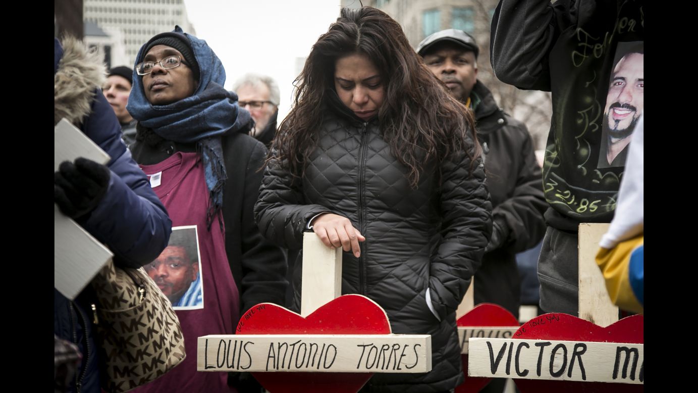 Veronica Aguilera stands over a cross for her late husband, Louis Antonio Torres, during a quiet march in Chicago on Saturday, December 31. Hundreds of people carried crosses for each person slain in Chicago last year. Torres was fatally shot in November. Data released by the Chicago Police Department shows that 2016 was <a href="http://www.cnn.com/2017/01/01/us/chicago-murders-2016/" target="_blank">the city's deadliest year</a> in two decades.