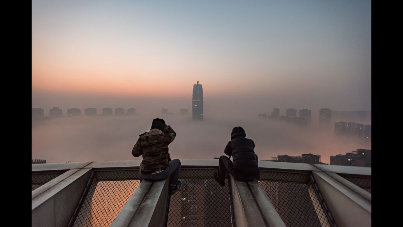 Photographers view heavy smog from the roof of a building in Zhengzhou, China, on Tuesday, January 3. China <a href="http://www.cnn.com/2017/01/03/asia/china-fog-alert/" target="_blank">issued its first-ever red alert for fog</a> in a number of northern and eastern regions. That followed some 24 cities issuing red alerts for air pollution. Red is the most serious level in the country's warning system.