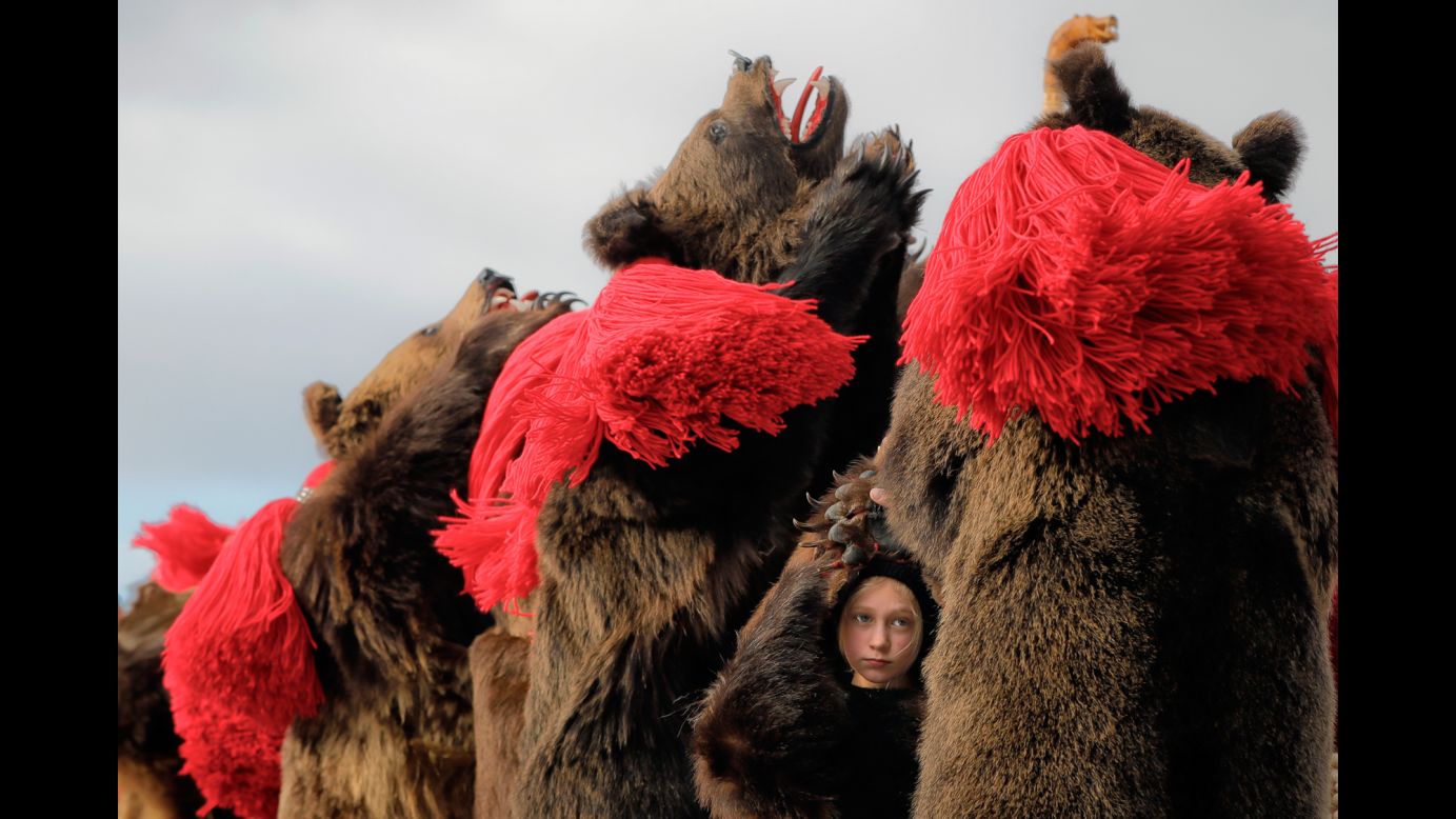 A child wears bear fur as she dances at a New Year's festival in Comanesti, Romania, on Friday, December 30. In that region, <a href="http://www.cnn.com/2015/11/01/travel/cnnphotos-bear-dance/" target="_blank">traditional "bear dancing"</a> is meant to drive away evil spirits.