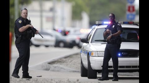 Police officers stand on the perimeter road at the Fort Lauderdale-Hollywood International Airport. 