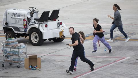 People run out on the tarmac in the aftermath of the shooting Friday, January 6, at the airport in Fort Lauderdale, Florida. <a href="http://www.cnn.com/2017/01/06/us/fort-lauderdale-airport-incident/index.html" target="_blank">Five people were killed and eight others were wounded</a>, officials said. 