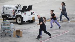 People run on the tarmac at Fort Lauderdale--Hollywood International Airport, Friday, January 6 in Fort Lauderdale, Florida.