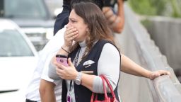 People react to a shooting at the  Fort Lauderdale--Hollywood International Airport on Friday
