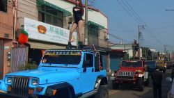 This picture taken on January 3, 2017 shows pole dancers performing on top of jeeps during the funeral procession of former Chiayi City county council speaker Tung Hsiang in Chiayi City, southern Taiwan.
Fifty pole dancers clad in black bikinis gave one Taiwan politician a raucous final send-off in an eyebrow-raising funeral parade that jammed traffic and drew crowds of onlookers.  / AFP / STR / Taiwan OUT        (Photo credit should read STR/AFP/Getty Images)