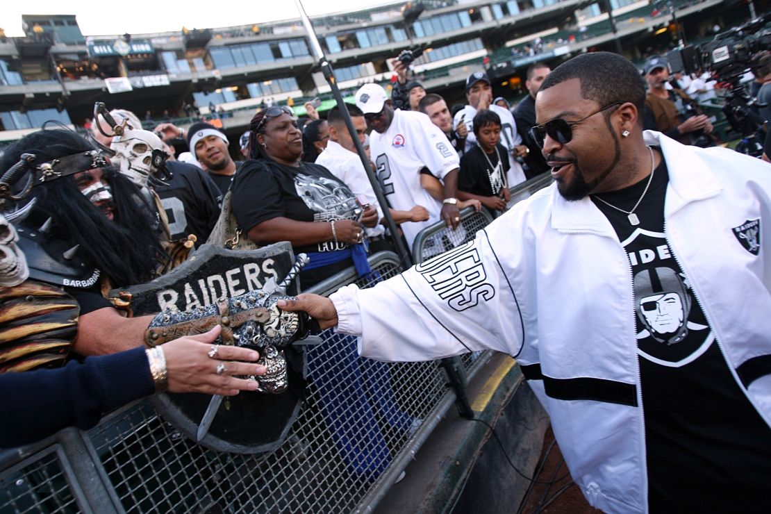 Rapper-actor Ice Cube greets Oakland Raiders fans before a game on September 14, 2009, at the Oakland-Alameda County Coliseum.