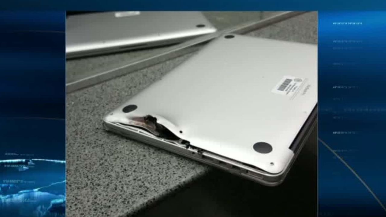 One of the shooter's bullets hit a laptop and ricocheted off, instead of hitting a man in the back.