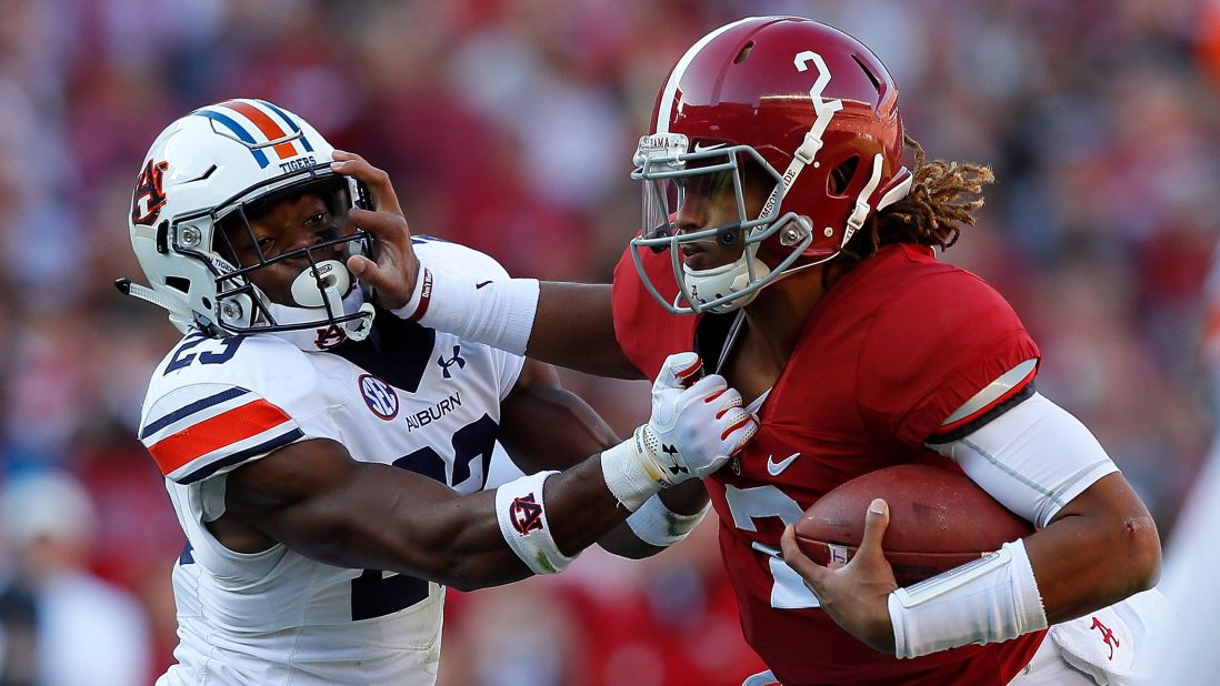 Alabama quarterback Jalen Hurts, right, tries to break a tackle by Auburn defensive back Johnathan Ford on November 26 in Tuscaloosa.