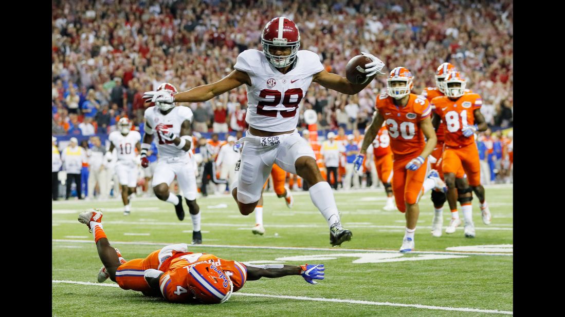 Alabama defensive Minkah Fitzpatrick returns an interception for a touchdown in the first quarter of the SEC Championship Game against Florida on December 3 in Atlanta. The Crimson Tide took the SEC title game 54-16.