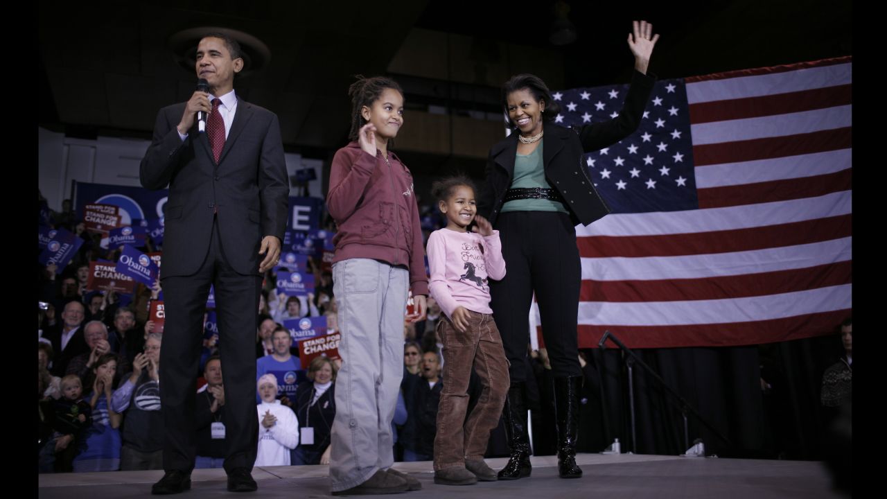 Barack Obama, then a Democratic presidential hopeful, addresses voters at a January 2008 rally in Des Moines, Iowa, accompanied by his wife, Michelle, and daughters Malia and Sasha, then 9 and 6, respectively. Click through the gallery to see how the Obama girls grew up before the nation after their father's 2008 election as President.