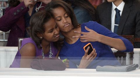 The first daughters take a selfie of themselves during the presidential inaugural parade on January 21, 2013, in Washington. Malia was 14 and Sasha 11 at the time of their father's second inaugural. 