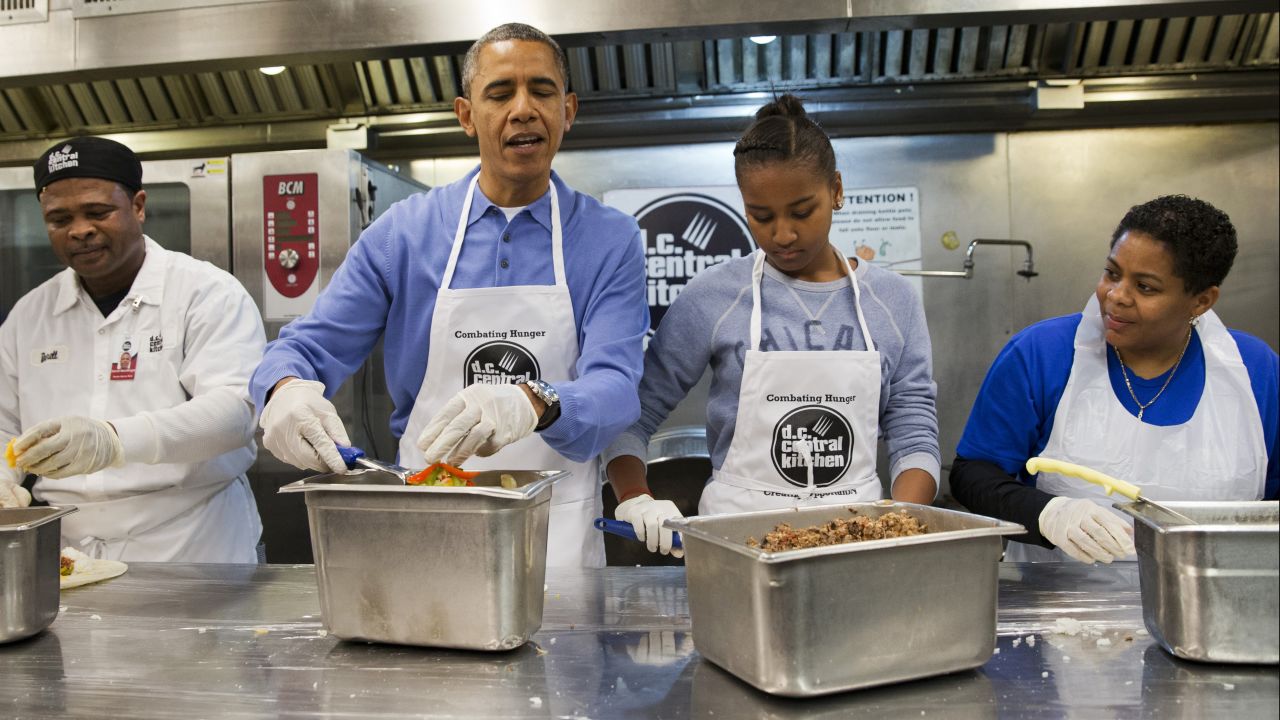 Obama and Sasha make burritos at DC Central Kitchen as part of a service project on Martin Luther King Jr. Day in January 2014.
