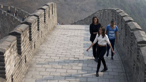 Michelle Obama shares a light moment with her daughters as they visit the Mutianyu section of the Great Wall of China in March 2014. 
