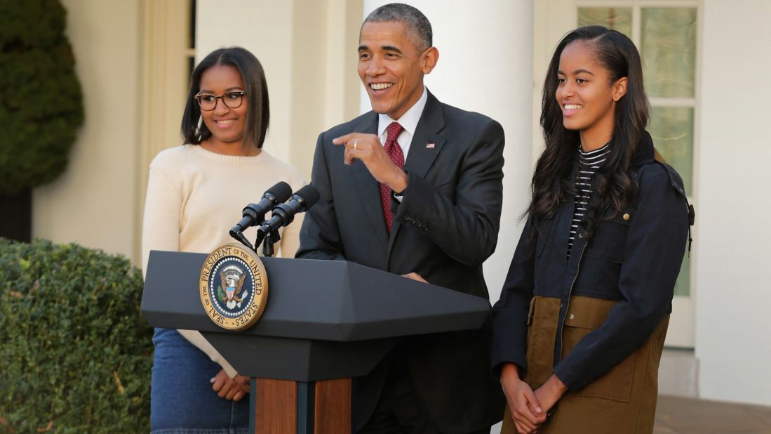 Sasha, left, and Malia join their dad as he delivers remarks for the turkey pardoning ceremony in the Rose Garden at the White House in November 2015.
