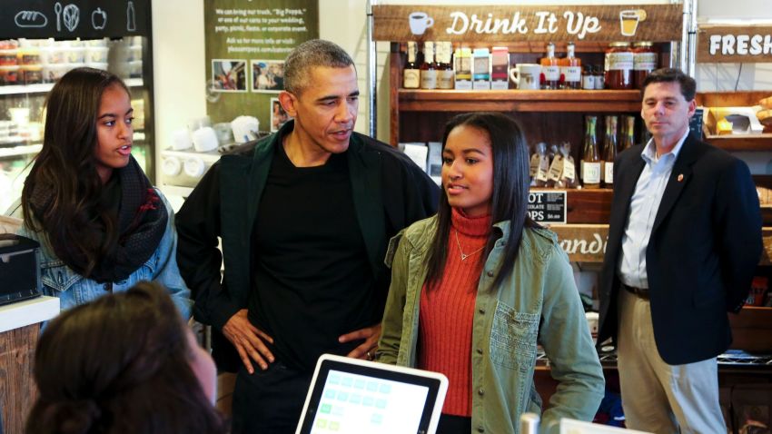 President Barack Obama buys ice cream for his daughters Malia and Sasha at Pleasant Pops during Small Business Saturday on November 28, 2015, in Washington, DC.
