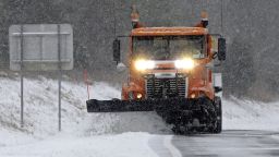 A truck plows sleet and snow from an onramp along Interstate 40 as snow from a winter storm blankets the area making driving conditions hazardous near Chapel Hill, N.C., Saturday, Jan. 7, 2017. (AP Photo/Gerry Broome)