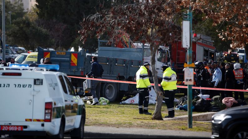 Israeli security forces gather around a flatbed truck at the site of a vehicle attack in Jerusalem on Sunday, January 8. 