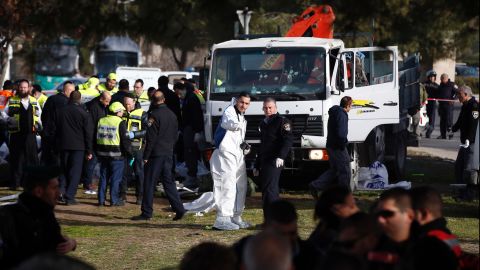 Israeli security forces and emergency personnel gather at the site of the vehicle attack. The attacker was shot and killed; note the bullet holes in the truck's windshield.