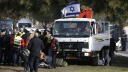 Israeli security forces and emergency personnel gather at the site of a vehicle-ramming attack in Jerusalem on January 8, 2017. A truck ploughed into a group of soldiers in Jerusalem in what police said was a "possible terrorist attack" in which at least four were killed and a number of people injured.