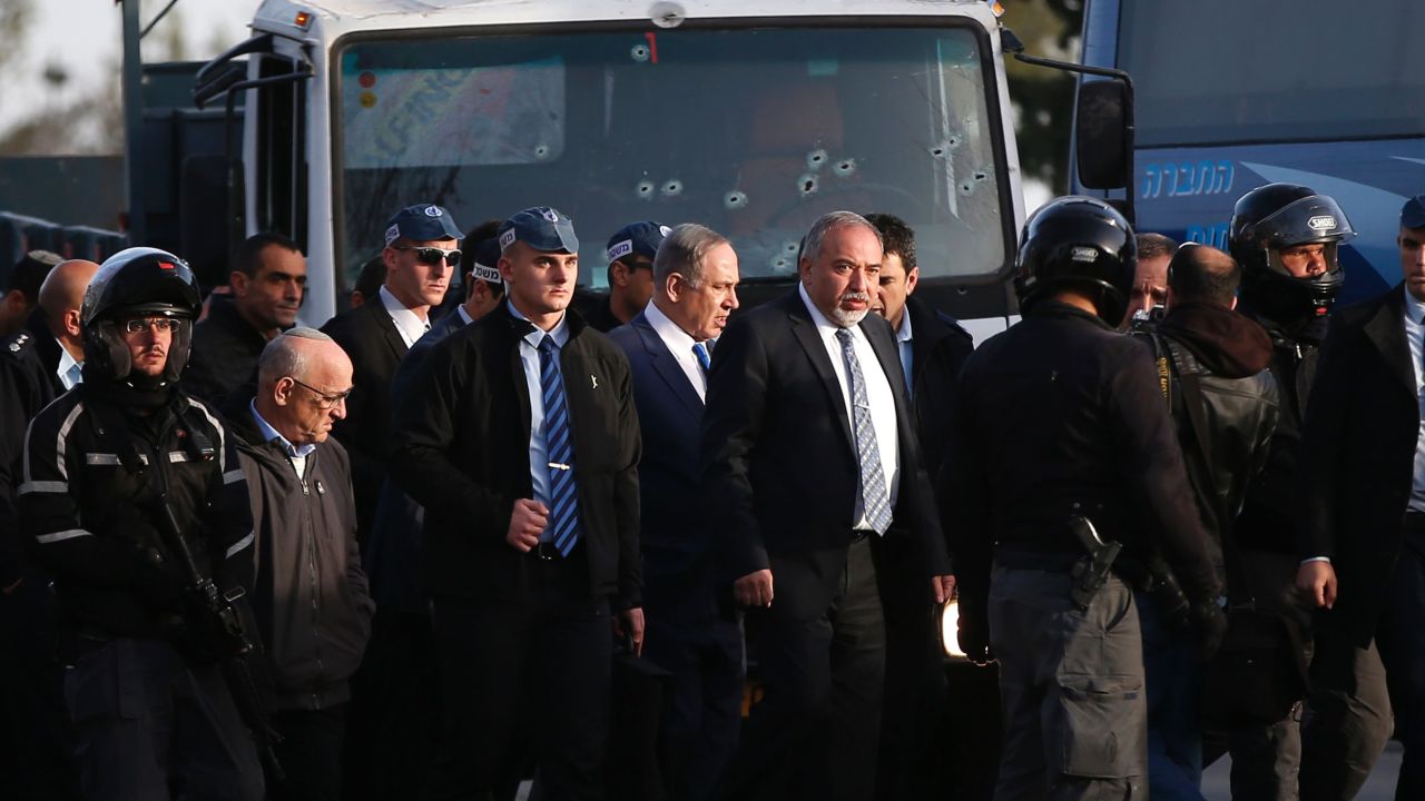 Israeli Defense Minister Avigdor Lieberman, center right, and Prime Minister Benjamin Netanyahu visit the site of the attack.
