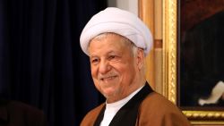 Iranian former president and head of the Expediency Council, Akbar Hashemi Rafsanjani arrives for a press conference after registering his candidacy for the upcoming Assembly of Experts elections at the interior ministry in Tehran on December 21, 2015. The 86-member Assembly's role is to monitor the work of the supreme leader, currently Ayatollah Ali Khamenei (portrayed in the background). The poll will coincide in February 2016 with parliamentary elections, which could see more moderates and reformists chosen on the back of Iran's recent nuclear deal with world powers. AFP PHOTO / ATTA KENARE / AFP / ATTA KENARE        (Photo credit should read ATTA KENARE/AFP/Getty Images)