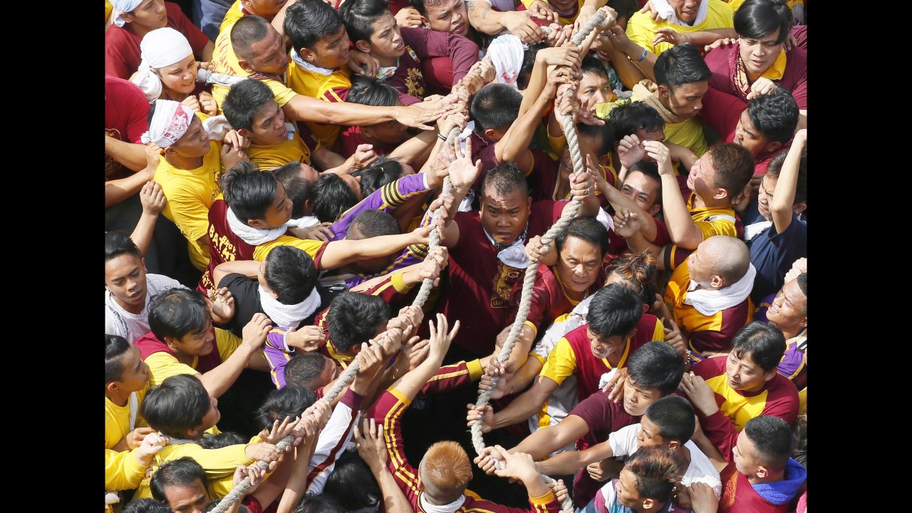 Filipino Roman Catholic devotees pull ropes that serve as a guide for the carriage of the Black Nazarene during the procession on January 9 in Manila, Philippines. The Philippine National Red Cross reported treating 899 patients.
