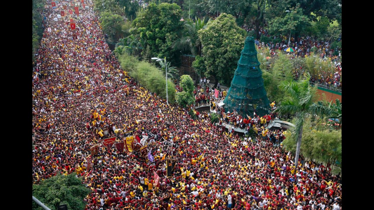 Filipino Roman Catholic devotees climb the carriage to kiss the image of the Black Nazarene during a procession to celebrate its feast day on Monday, January 9 in Manila, Philippines. The Black Nazarene is a dark wood sculpture of Jesus brought to the Philippines in 1606 from Mexico and considered miraculous by Filipino devotees. 