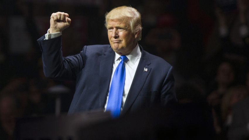 Republican presidential candidate Donald Trump makes a fist at the end of his rally at the SNHU Arena on November 7, 2016 in Manchester, New Hampshire.