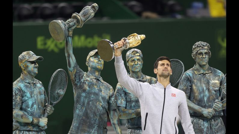 Novak Djokovic holds up his trophy after winning the Qatar Open final on Saturday, January 7. Behind him were human statues of past Qatar Open champions, including Djokovic himself (raising the trophy). Djokovic <a href="index.php?page=&url=http%3A%2F%2Fwww.cnn.com%2F2017%2F01%2F07%2Ftennis%2Ftennis-qatar-djokovic-murray%2Findex.html" target="_blank">defeated Andy Murray in the final,</a> ending Murray's 28-match unbeaten run.