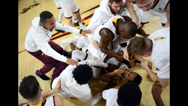 Tra Holder is mobbed by his Arizona State teammates after sinking two free throws to beat Colorado 78-77 on Thursday, January 5.