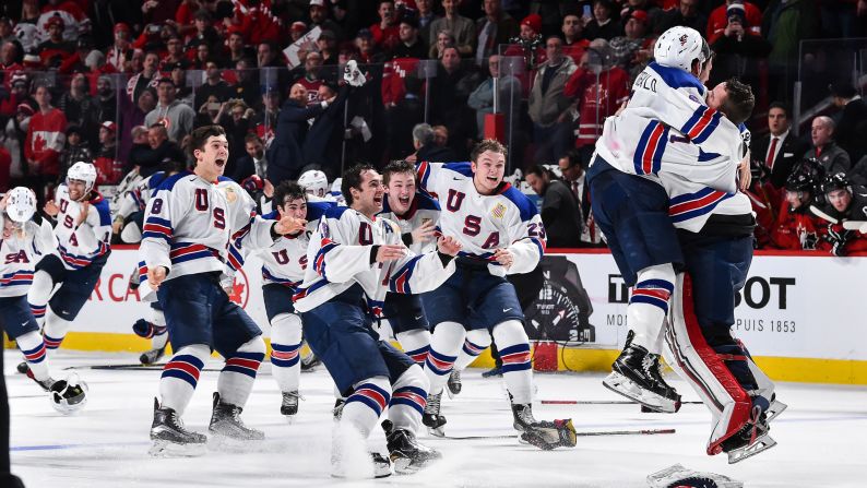 American hockey players rush to goalie Tyler Parsons after winning the World Junior Championship on Thursday, January 5. The United States defeated Canada in a shootout.