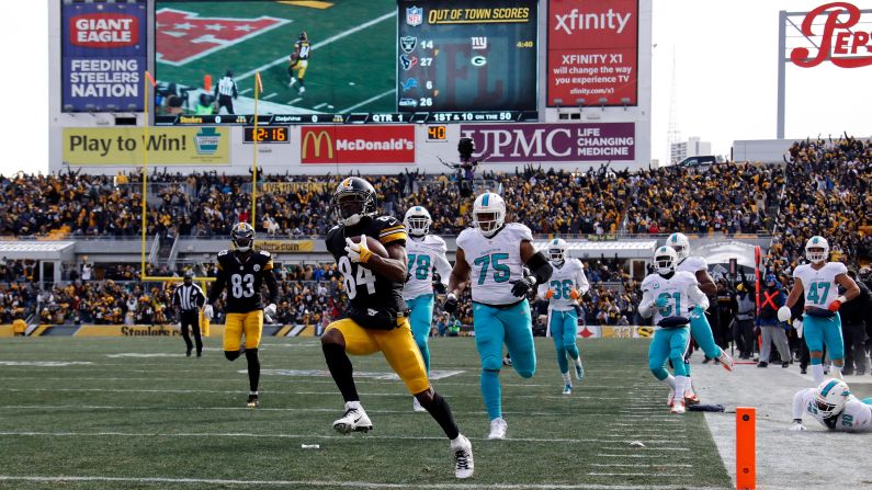 Pittsburgh wide receiver Antonio Brown scores the opening touchdown in the Steelers' playoff win over Miami on Sunday, January 8. Brown had two touchdowns and 124 receiving yards in the 30-12 victory.