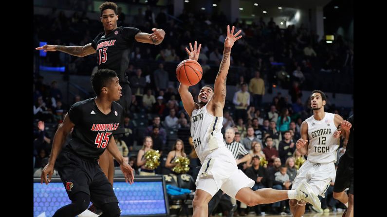 Georgia Tech's Tadric Jackson has the ball knocked away by Louisville' Ray Spalding, top left, during a game in Atlanta on Saturday, January 7.