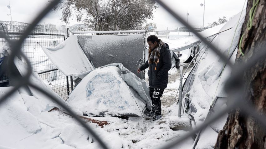 A migrant stands next to a snow-covered tent at the Moria hotspot on the island of Lesbos , following heavy snowfalls on January 7, 2017. 
The number of migrants arriving in Europe by two main sea routes in 2016 plunged by almost two-thirds to 364,000 compared with the previous year, EU border agency Frontex said Friday. Frontex pointed to an EU border deal with Turkey which came into effect in March as having paved the way to a massive decline in the arrival of Syrian refugees and other migrants in Greece.
 / AFP / STR        (Photo credit should read STR/AFP/Getty Images)