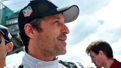 US Actor Patrick Dempsey who drives the Porsche 911 RSR N? 77 smiles in the pit before the start of the 82nd Le Mans 24 hours endurance race, on June 14, 2014 in Le Mans, western France. Fifty-six cars with 168 drivers are participating on June 14 and 15 in the Le Mans 24-hours endurance race. AFP PHOTO / GUILLAUME SOUVANT        (Photo credit should read GUILLAUME SOUVANT/AFP/Getty Images)