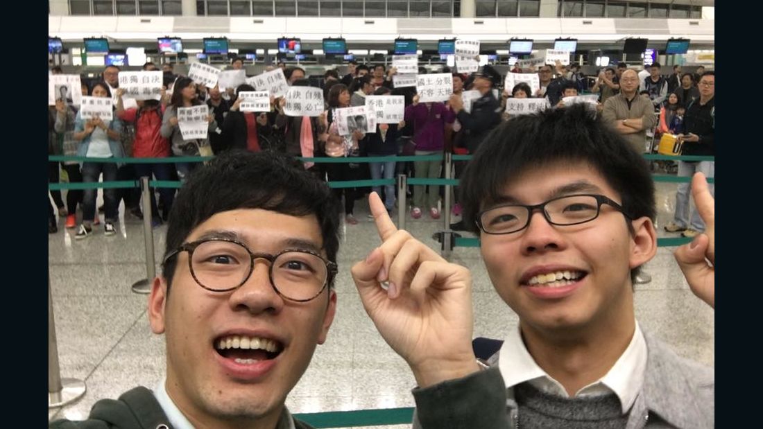Hong Kong pro-democracy politicians Nathan Law and Joshua Wong pose for a selfie with protesters targeting them.
