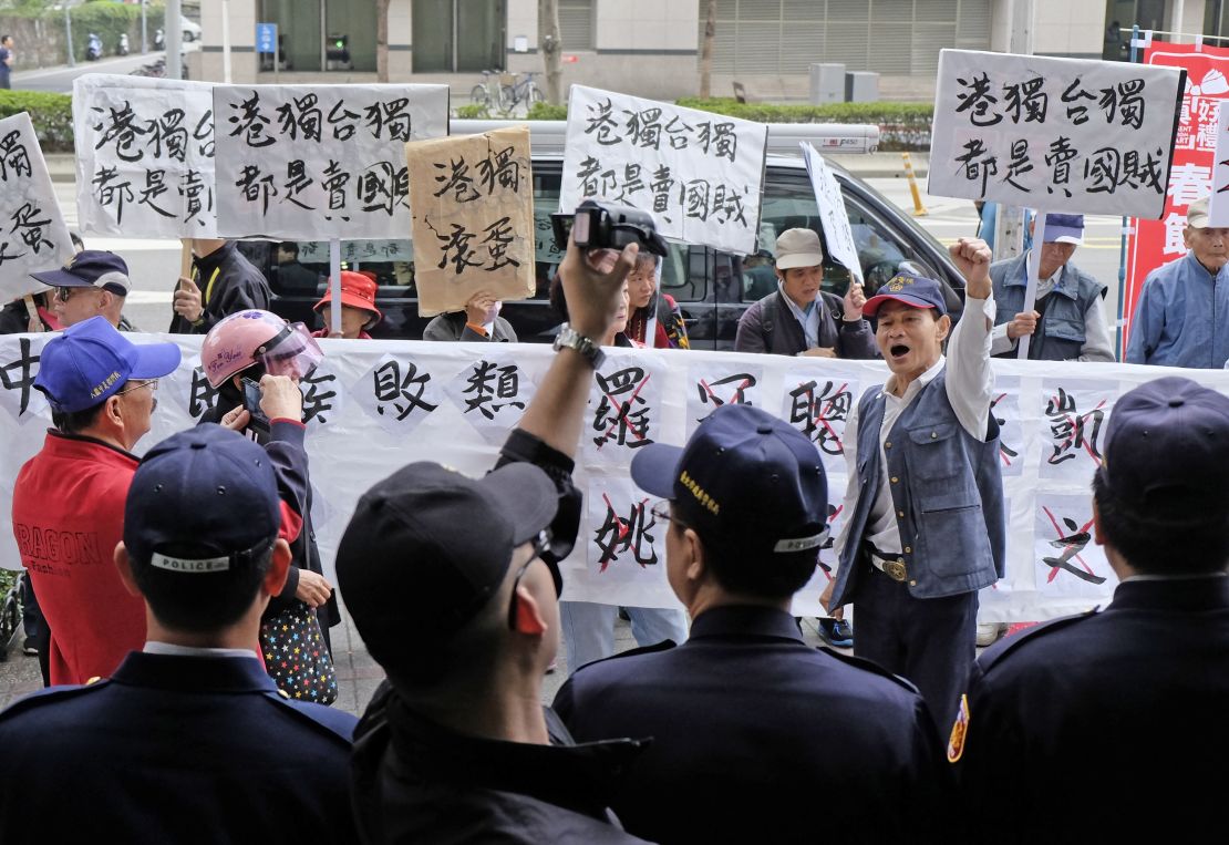 Pro-China protesters waving placards reading "independence will get you nowhere" greeted Hong Kong pro-democracy activist Joshua Wong and other lawmakers in Taipei.