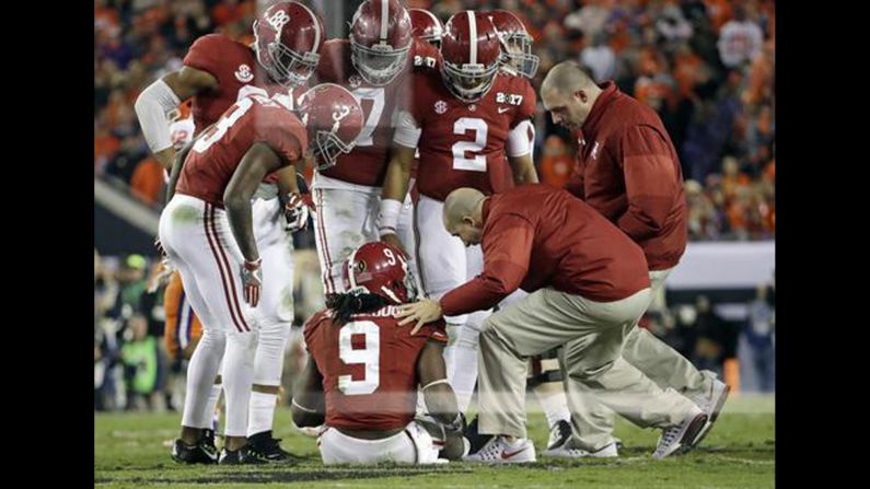 Alabama running back Bo Scarbrough is looked at by trainers after getting hurt in the second half. He didn't return to the game. Scarbrough had two touchdowns in the first half.