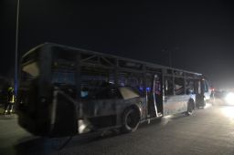 Security forces remove a damaged bus after blasts in Kabul last month. 