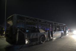 Security forces remove a damaged bus after blasts in Kabul last month.